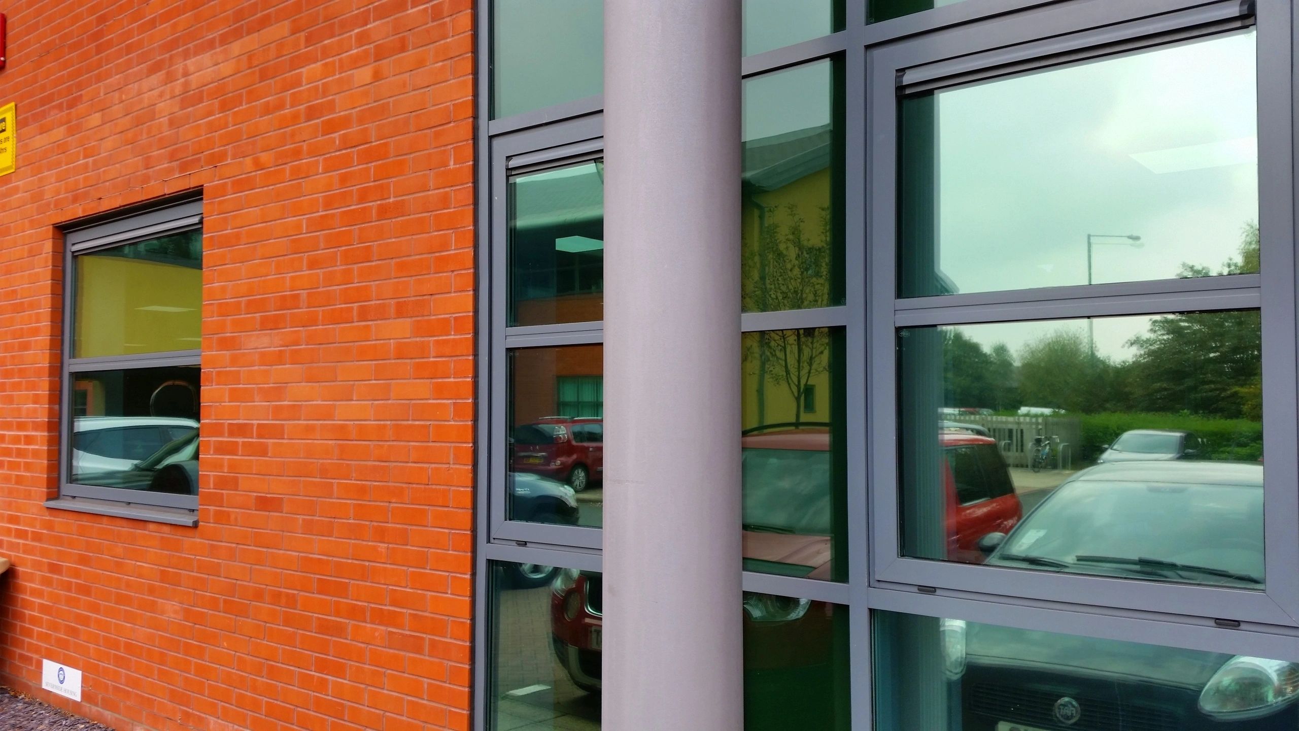 Orange brick building with glass